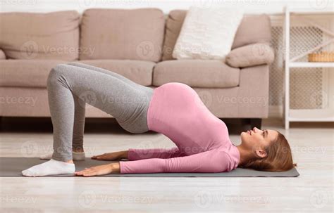 Pregnancy Fitness. Focused young pregnant woman doing prenatal shoulder