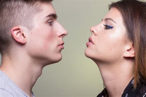 Young Adult Man Woman Girl Boy Looking at Each Other Close by Stock