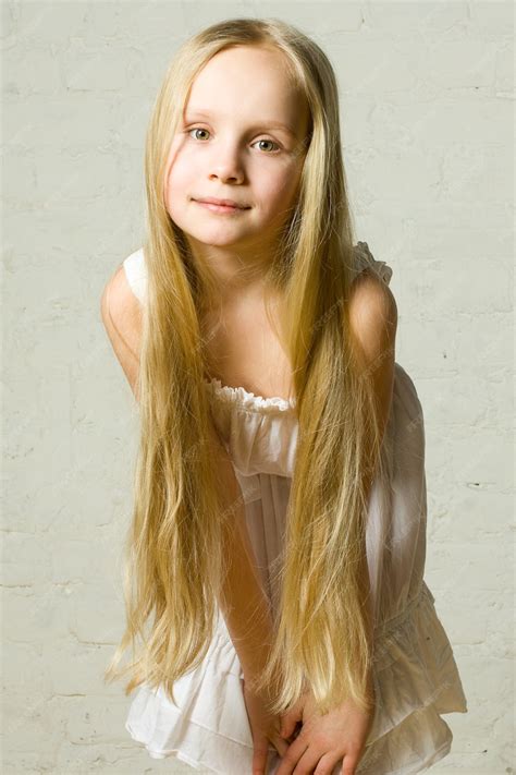 Premium Photo | Smiling child girl with long blond hair - portrait