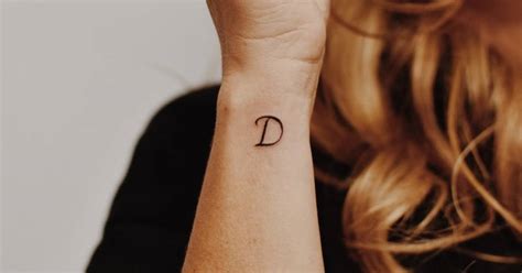 "D" letter tattooed on the wrist