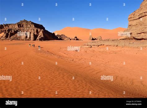 Algeria, Sahara, Tassili N'Ajjer National Park, People hiking between ...
