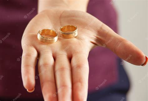 Premium Photo | Woman hand holding woman and man ring