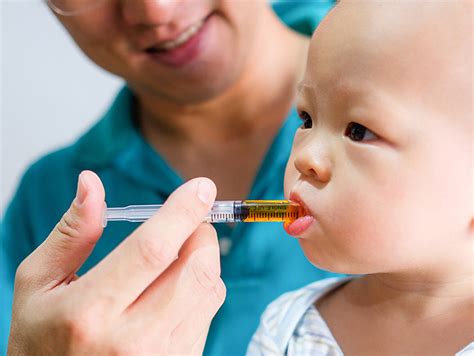 giving medicine   child