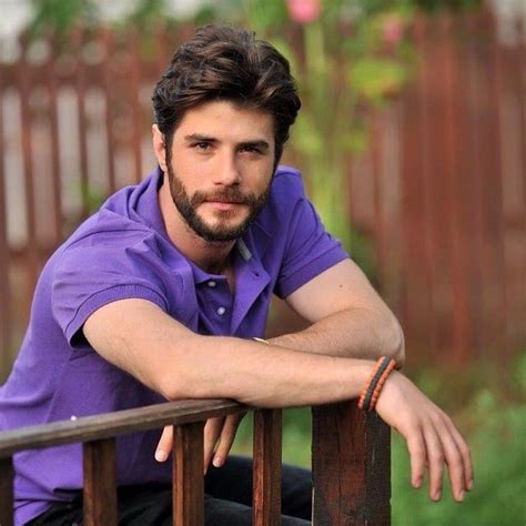 a man sitting on top of a wooden bench