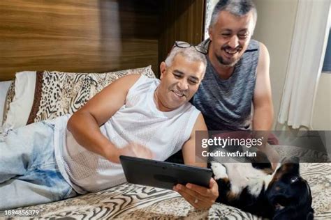 elderly gay couple computer stock  high res pictures
