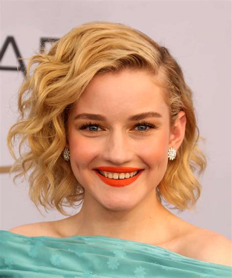 Julia Garner Medium Wavy Dark Blonde Bob Haircut with Side Swept Bangs