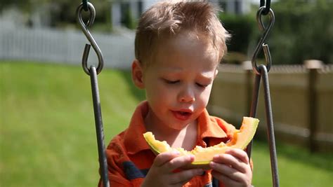 Young Boy Eating Melon On Swing Stock Footage Video 465424 - Shutterstock