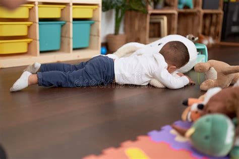 Adorable Toddler Playing with Dolls Lying on Floor at Home Stock Image ...