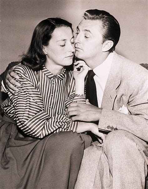 Robert Mitchum and Wife Hugging Pictures | Getty Images