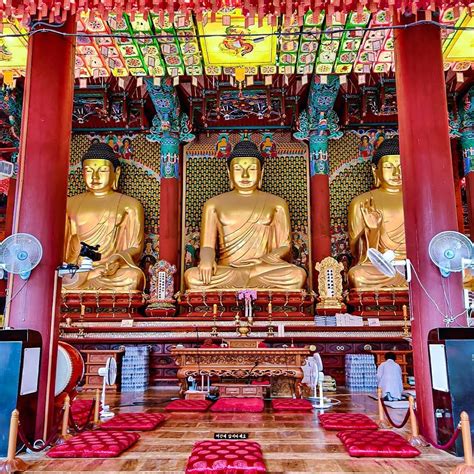 there are many buddhas in the room with red and gold decorations on the ...