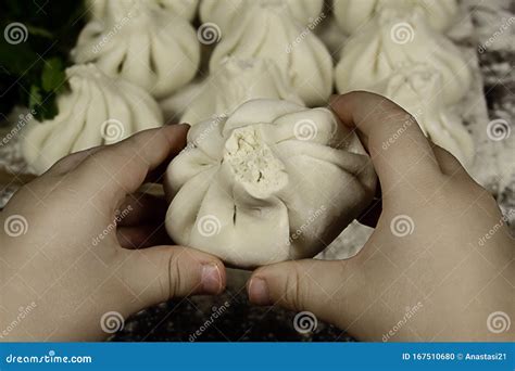 Children`s Hands are Holding Khinkali. Fresh Khinkali with Dough Meat ...