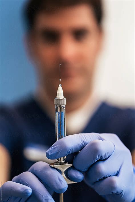 "Doctor With Syringe Is Preparing For Injection" by Stocksy Contributor