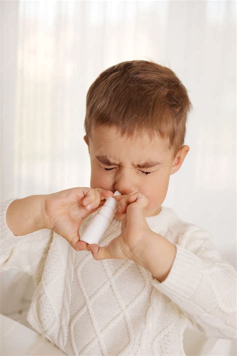 Premium Photo | Little boy spraying medicine in nose, nose drops