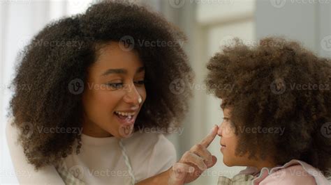 Happy family at home kitchen cooking together African American mother