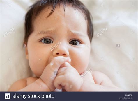 baby lying  sucking thumb high resolution stock photography