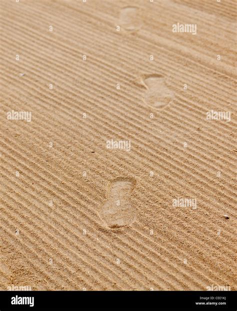 Shoe footprints in rippled sand on beach Stock Photo - Alamy