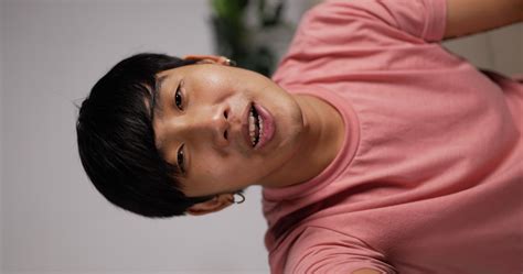 Vertical POV Video Call Portrait of Asian young man talking to friends
