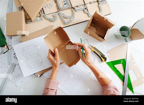 Box maker analysing box, prepared to make marks with a pencil Stock Photo - Alamy