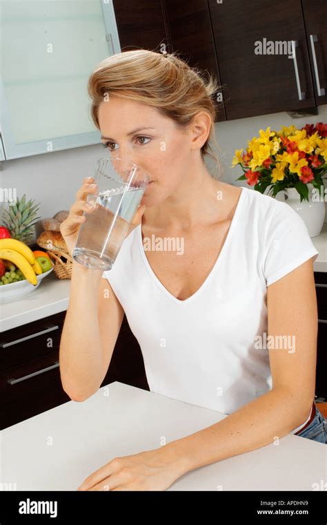 woman  kitchen drinking water stock photo alamy