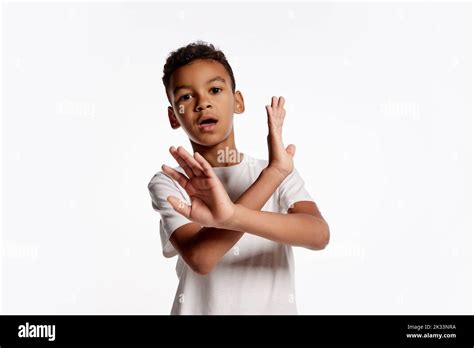 Portrait of scared african little boy in white tee expressing emotions ...