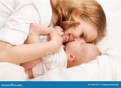 Happy Family. Baby and Mother Play, Kiss, Tickle, Laugh in Bed Stock ...