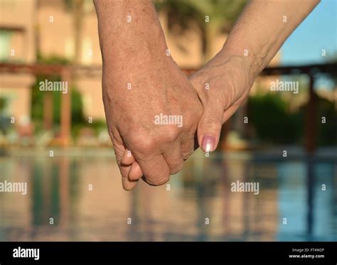 Holding hands together Stock Photo - Alamy