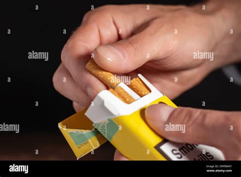 close up man hand holding peel it off cigarette pack prepare smoking a ...