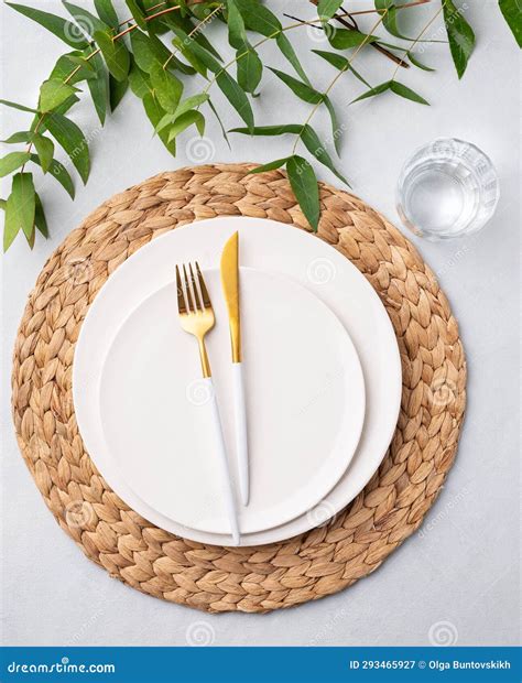 festive table setting  white plates glass  cutlery   light
