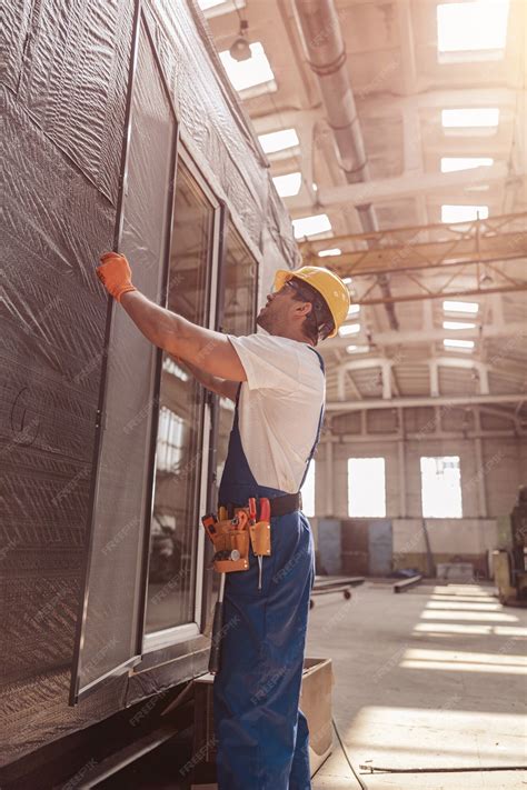 Premium Photo | Male builder installing sliding glass door at