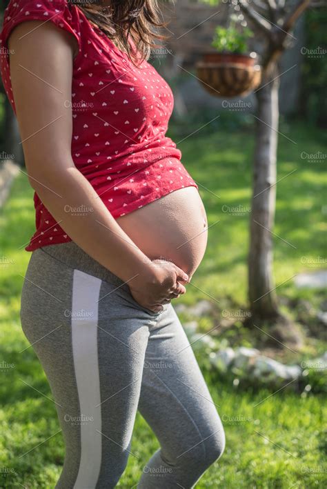 Pregnant woman shows his belly. In t | High-Quality People Images