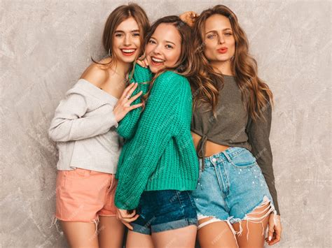 Tres jóvenes hermosas sonrientes hermosas chicas en ropa de moda de