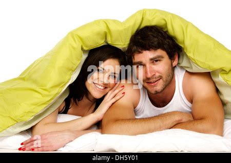 Sexy couple in bed romance under sheets naked snuggling Stock Photo - Alamy
