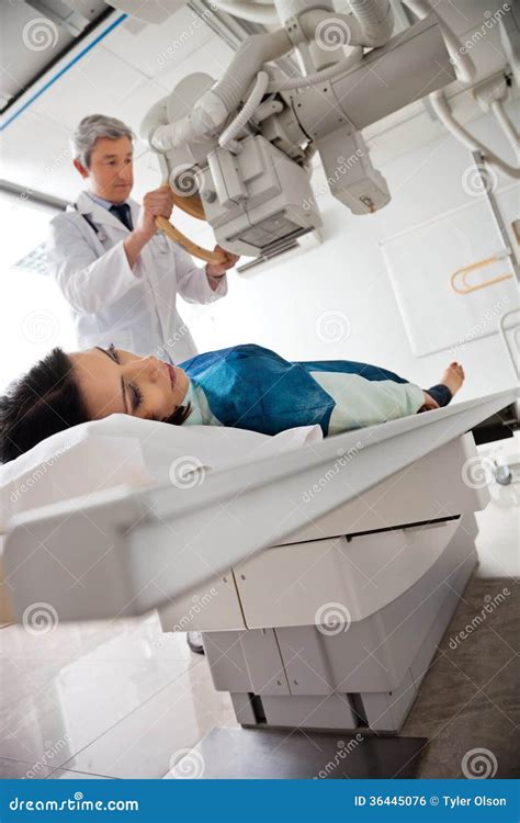 Radiologist Setting Up Machine To X-ray Female Stock Photo - Image of ...