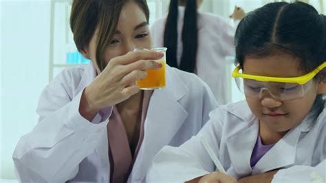 Asian schoolgirls are studying science and technology in a lab