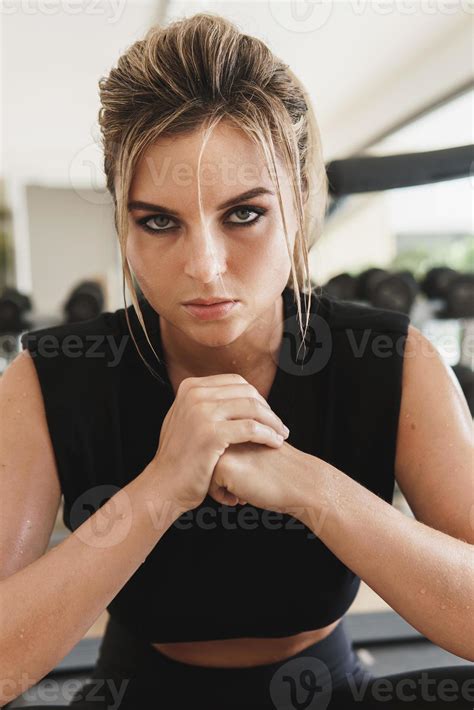 Portrait of young athletic woman in gym 16236215 Stock Photo at Vecteezy