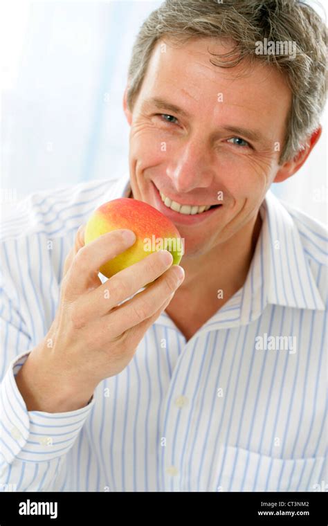 MAN EATING FRUIT Stock Photo - Alamy