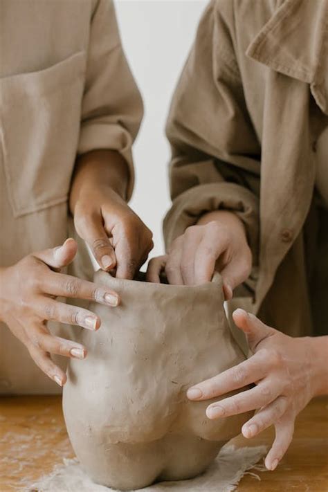 Two People Making a Sculpture out of Clay · Free Stock Photo