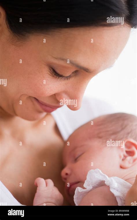 Mother holding her sleeping baby Stock Photo - Alamy