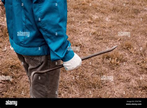 The worker holds a pry bar in his hand. Installation work in rural ...