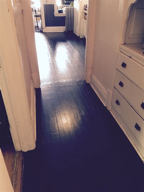 The old linoleum kitchen floor and the grey painted hallway floor are