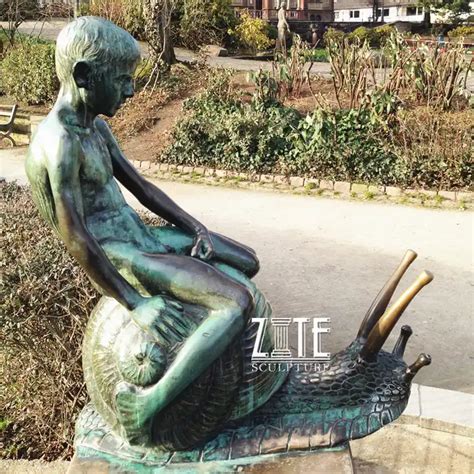 life size bronze naked boy riding snail statue  garden