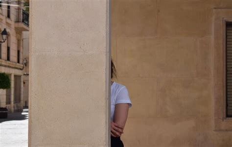 premium photo woman hiding  pillar