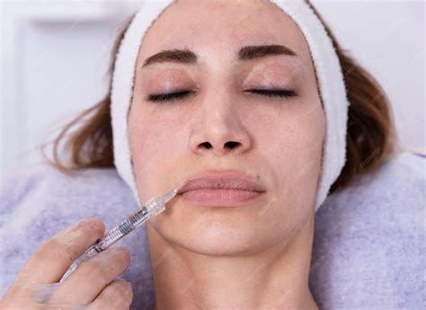 premium photo cosmetologist performs lip filler injections