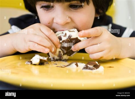 Little boy eating messy ice cream bar Stock Photo - Alamy