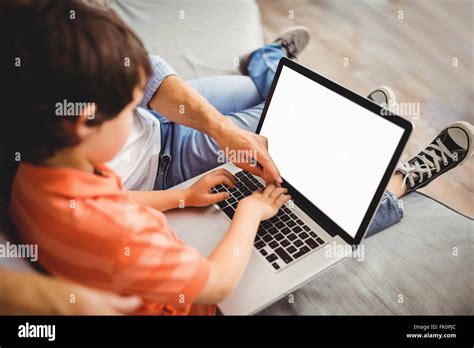 Father and son working on laptop Stock Photo - Alamy