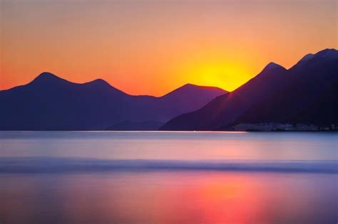 Premium AI Image | A sunset over the mountains with the sun setting ...
