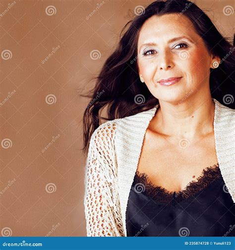Pretty Brunette Confident Mature Woman Posing Cheerful on Warm Brown