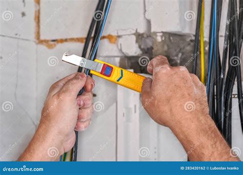 Electrician Stripping Insulation from Power Cables with Wire Stripper ...