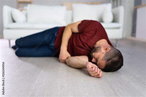 Unconscious Young Man Lying On Floor Stock Photo | Adobe Stock
