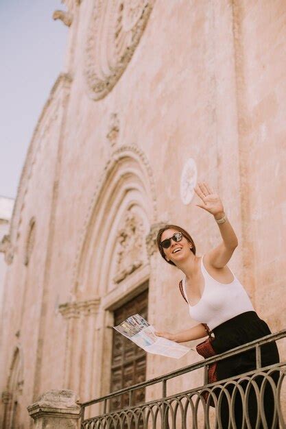 Premium Photo | Female tourist with a city map by the church san ...